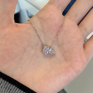 Close-up of S925 silver necklace featuring radiant square and heart-cut diamond pendants
