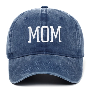 Detail of MOM embroidery on vintage denim blue cotton baseball cap with stitch texture