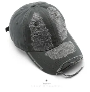 Top view of distressed dark grey washed cotton baseball cap with vintage frayed hole texture