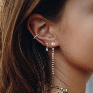 Detailed view of silver snowflake tassel earrings and ear cuff set with zirconia studs