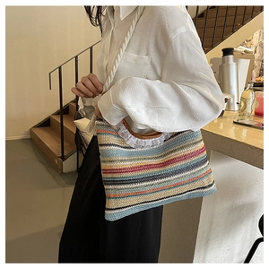 Detailed close-up of colorful woven straw handbag with wooden handle and lace trim