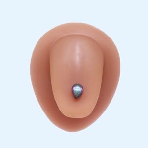 Close-up of teardrop purple-green gradient tongue ring on silicone body model