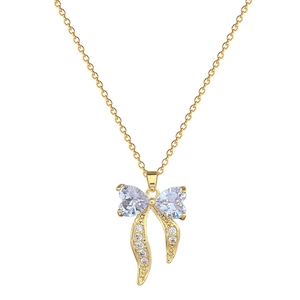 Elegant gold bow heart necklace with sparkling crystals on a minimalist chain