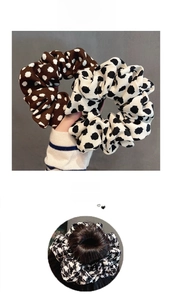 Detail of polka dot and houndstooth linen scrunchies styled on a hair bun