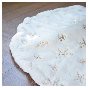 Detailed texture of white faux fur Christmas tree skirt with golden sequin snowflakes