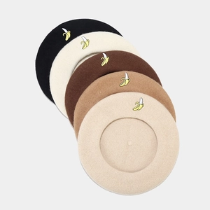 Detailed embroidery of banana pattern on wool berets in five elegant neutral colors