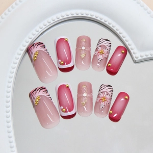 Pink gradient press-on nails with 3D lily flowers, bows, and pearls in coffin shape