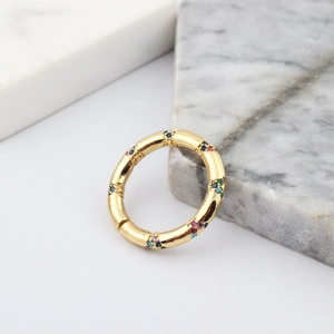 Macro detail of gold bamboo ring band set with multicolored rainbow crystals