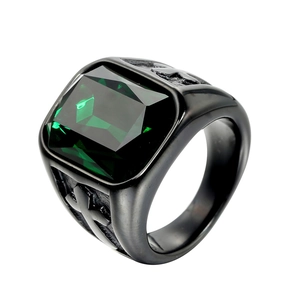 Macro view of titanium steel ring with green square gemstone and embossed cross patterns