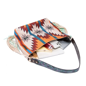 Macro detail of large woven bohemian tote bag showing spacious interior with daily essentials