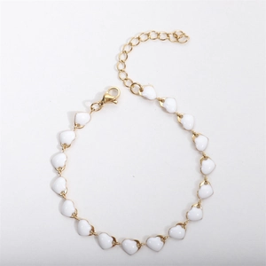 Detail of 18k gold plated heart bracelet with white enamel drops and lobster clasp