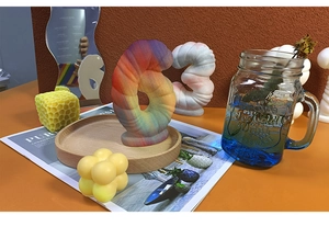 Detailed view of rainbow gradient 3D number 6 candle with textured spiral pattern