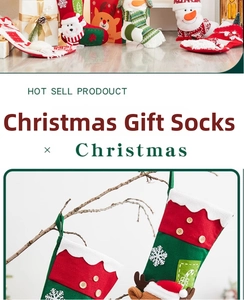 Detail of Christmas stocking with 3D Santa and Reindeer designs hanging on branches