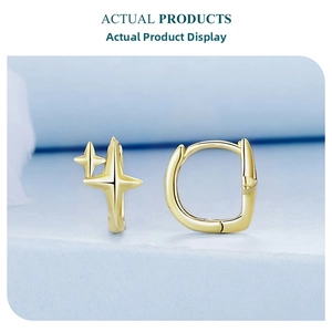 Close-up of golden s925 silver star hoop earrings featuring polished four-point star charms