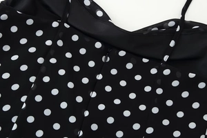 Detailed view of the invisible zipper and polka dot chiffon fabric on the dress