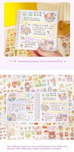 Detail of spiral-bound grid notebook with decorative cartoon stickers and DIY layout