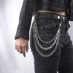 Three-layer silver metal pants chain in punk style hanging on black denim jeans