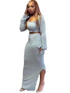 Grey ribbed knit two-piece set featuring long sleeve crop top and slit maxi skirt