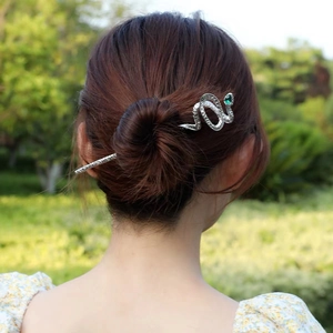 Silver snake hair pin with green rhinestone worn in a bun, elegant Chinese hair stick