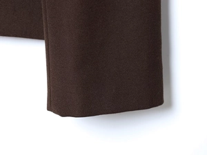 Macro detail of dark brown twill fabric blazer cuff showing fine stitching and texture