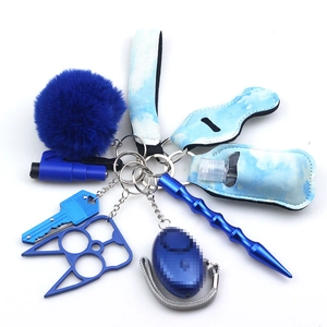 Detail view of blue neoprene safety keychain kit including alarm and accessories