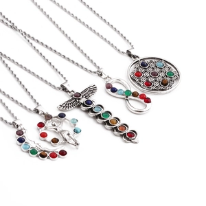 Set of 4 silver chakra necklaces with healing stones and mystical spiritual symbols