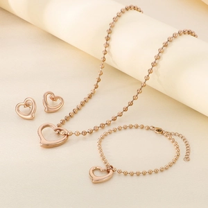 Detailed view of rose gold hollow heart jewelry set with necklace bracelet and stud earrings