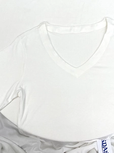 Slim fit white V-neck short sleeve cotton t-shirt for women in a flat lay minimalist view