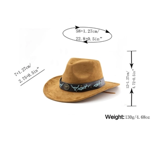 Detailed view of suede cowboy hat with bull head buckle and blue embroidery