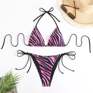 Pink and black zebra print halter bikini set with side-tie bottoms on a white background