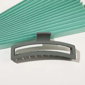 Macro view of a large matte dark grey rectangular hollow hair claw clip for thick hair