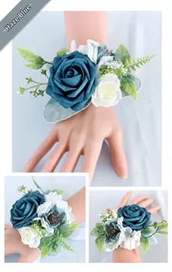 Detail of dusty blue artificial rose wrist corsage with white ribbons for wedding decor