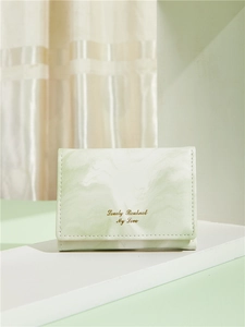 Detail of light green marble texture wallet with golden text on high-quality PU leather