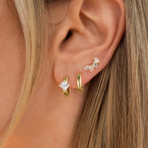 Detailed view of 18K gold earrings set with square and marquise-cut cubic zirconia