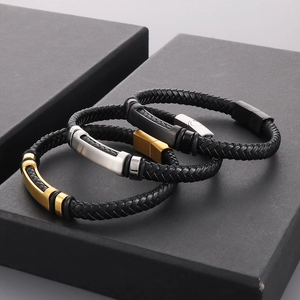 Three woven leather bracelets with gold, silver, and black metal clasps in a gift box