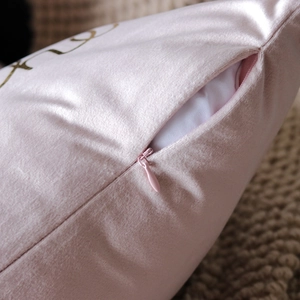 Macro shot of invisible zipper and soft pink velvet texture on the cushion cover