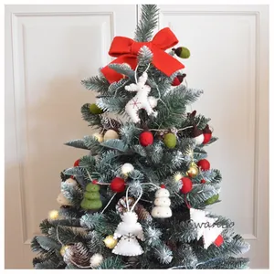 Detailaufnahme von handgefertigten Filz-Engel und Rentier-Anhängern an einem Weihnachtsbaum