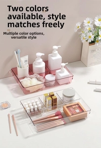 Close-up of clear multi-compartment organizer for cosmetics and makeup brushes
