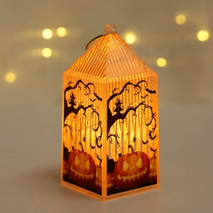 Macro detail of glowing orange Halloween lantern with black spooky bats and owl silhouettes