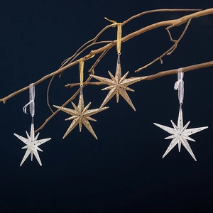 Champagne gold and silver glitter star ornaments hanging on branches for Christmas tree decor