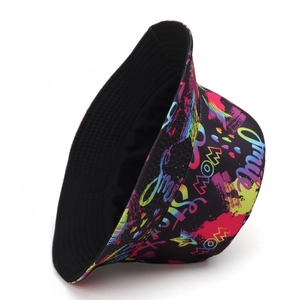 Detail of reversible bucket hat featuring vibrant neon graffiti print on black fabric
