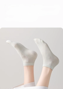Detail of breathable mesh knit texture on light grey silk blend summer ankle socks