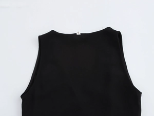 Detail shot of the sleeveless jumpsuit collar and shoulder with a size S inner label
