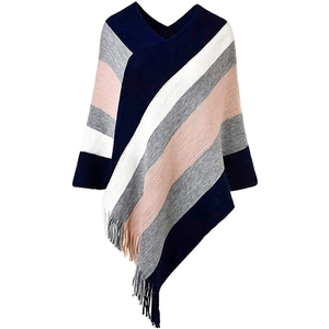 Close-up of color block knit poncho featuring colorful stripes and delicate fringe tassels