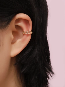 Detailed view of a gold-plated flower ear cuff with small sparkling zircon stones