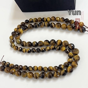 Macro shot of 128 faceted natural yellow tiger eye stone beads for DIY jewelry making