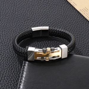 Detail of black woven leather punk bracelet with silver and gold metal rivets on leather