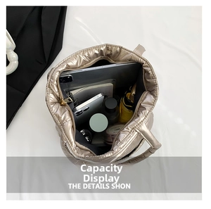 Spacious interior of champagne gold quilted puffer tote bag showing storage capacity