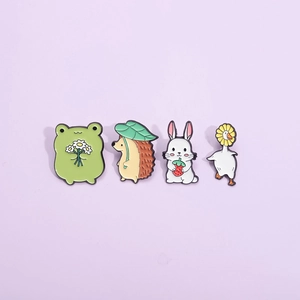 Detailed view of colorful cartoon animal enamel pins including frog, hedgehog, rabbit and duck