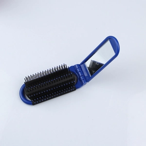 Detail view of open foldable blue hairbrush with mirror and black massage bristles